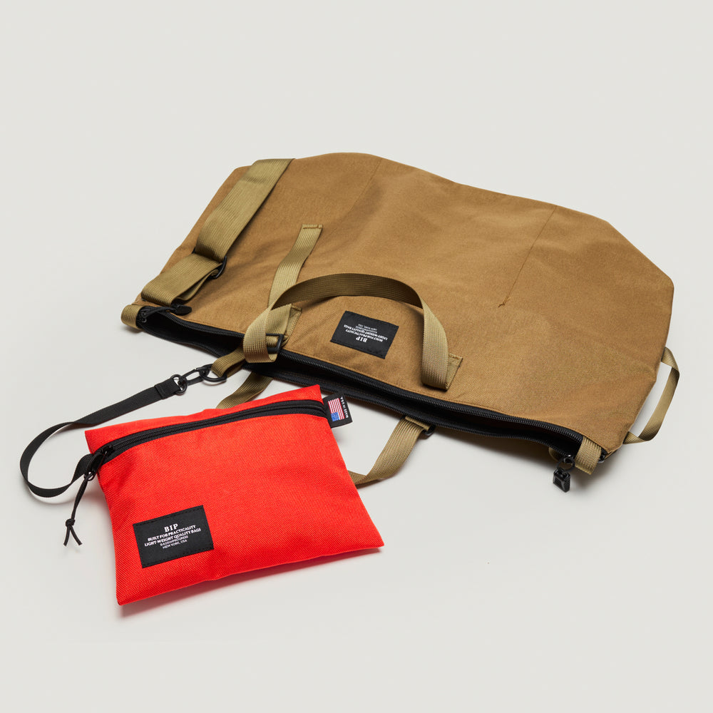Khaki colored canvas tote bag with detachable interior red canvas zip pouch