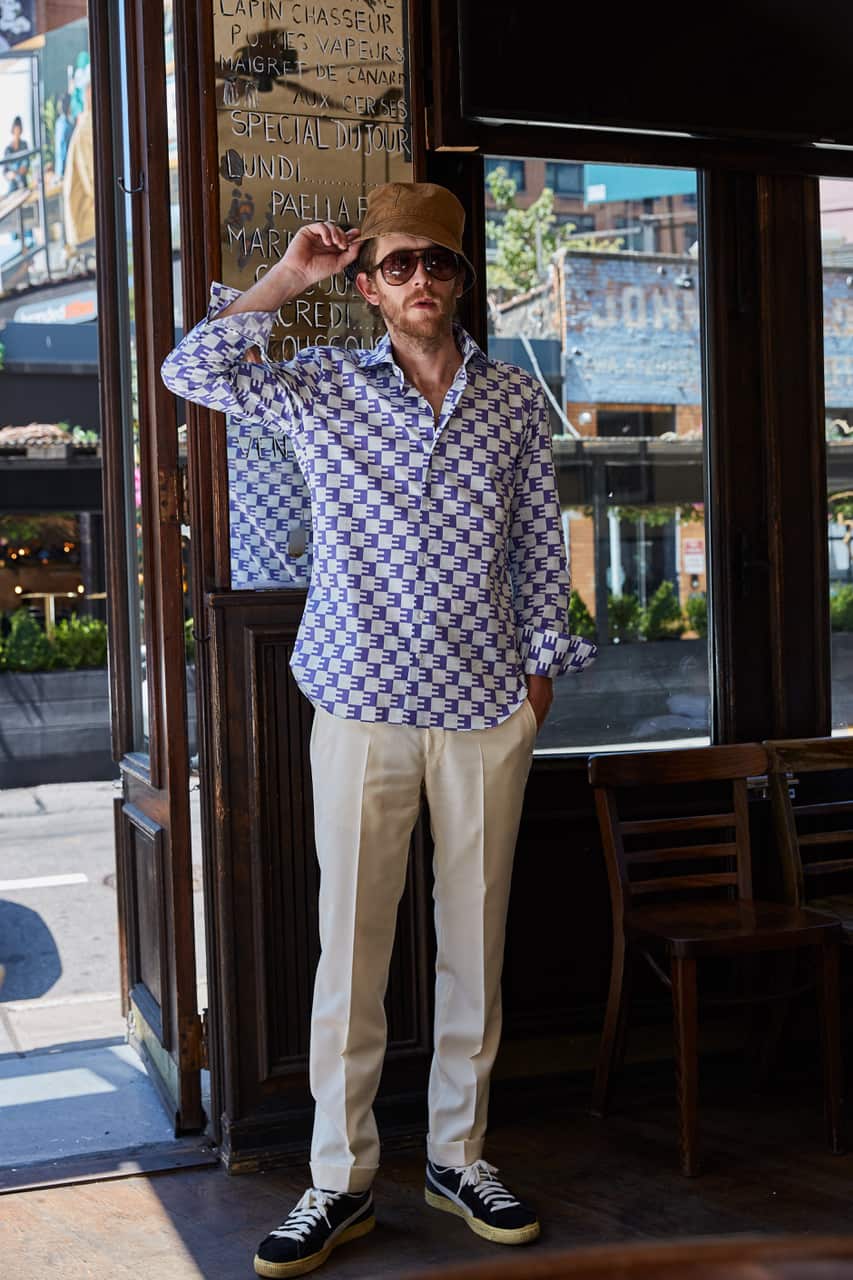 male model wearing lilac & white long sleeve button down men's shirt & khaki pants