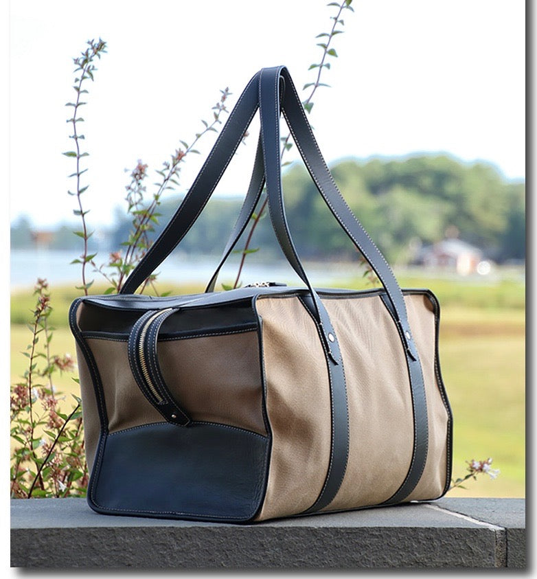 Three quarter view: Tan cotton twill weekender bag with leather handles