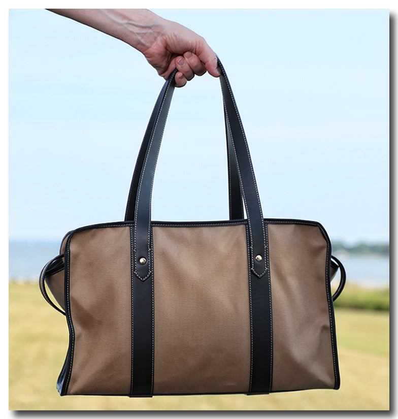 Hand held tan cotton twill weekender bag with leather handles