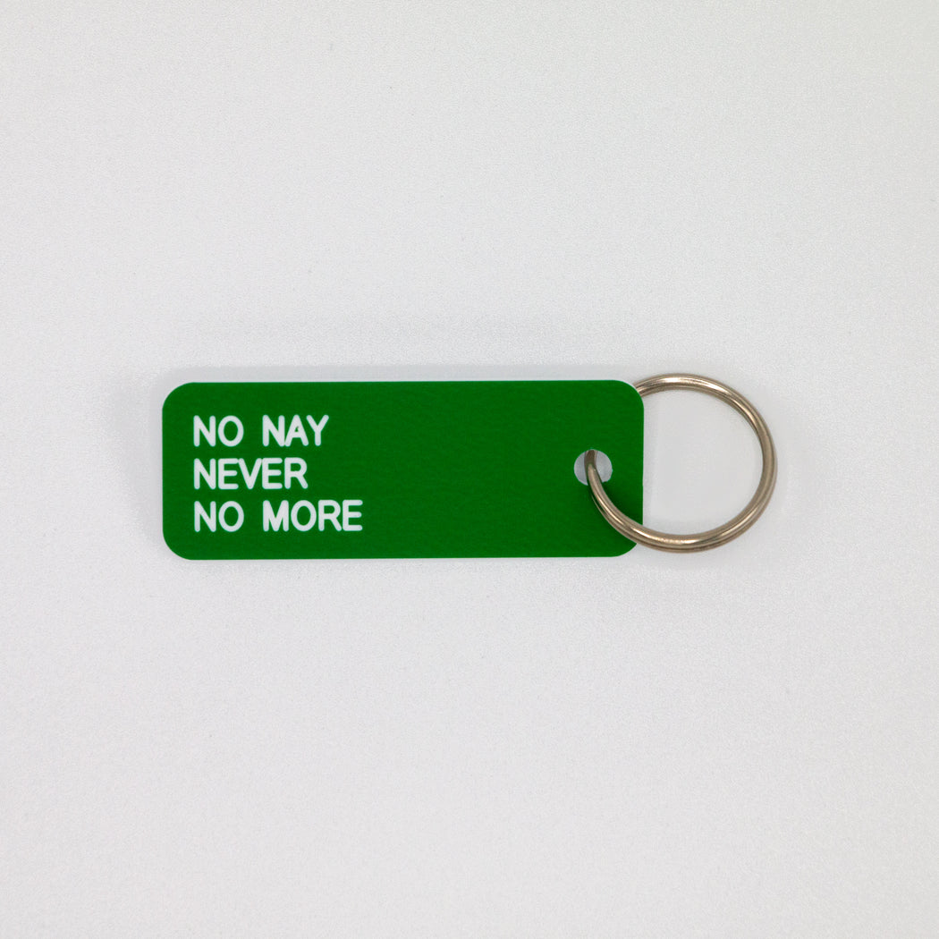 Green rectangular key tag reading "NO NAY NEVER NO MORE" in white print