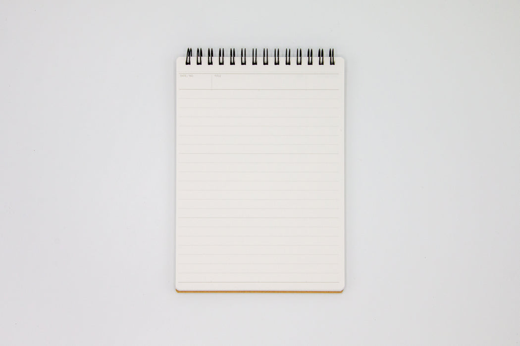 White lined paper inside Mnemosyne Note Pad with top spiral binding