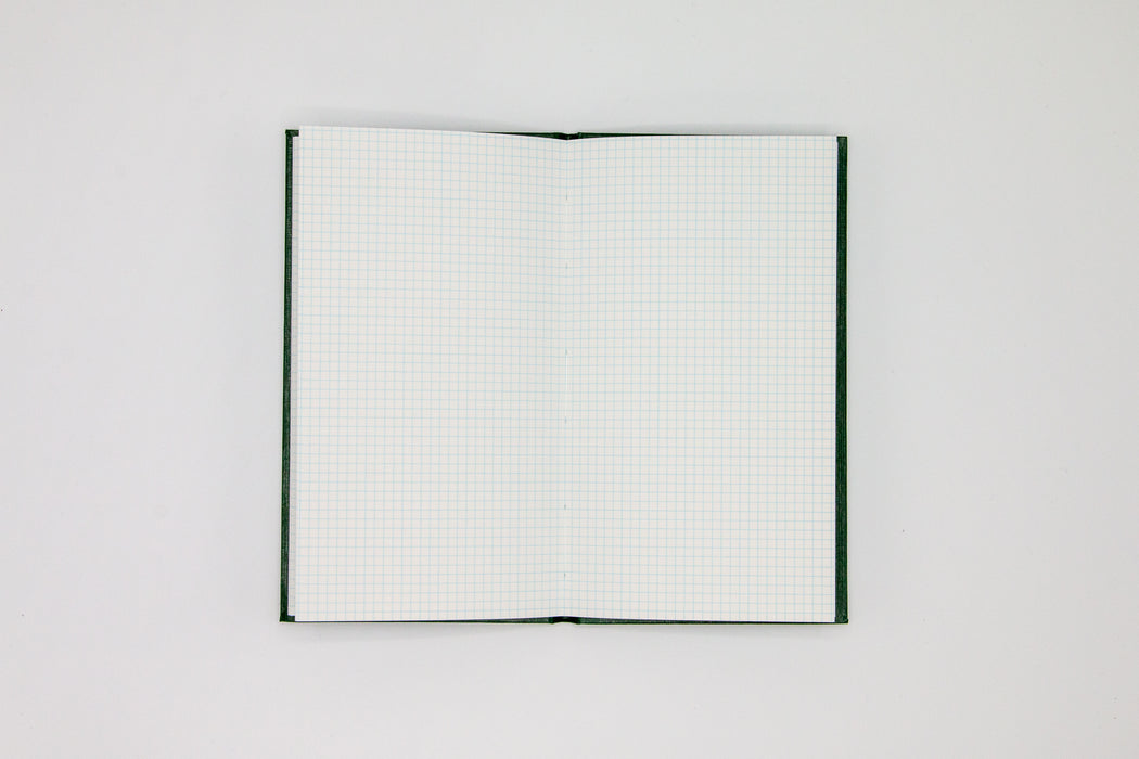 Double page spread of grid pages inside Japanese green sketch book