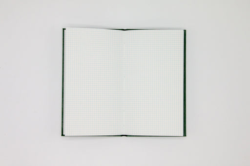 Double page spread of grid pages inside Japanese green sketch book