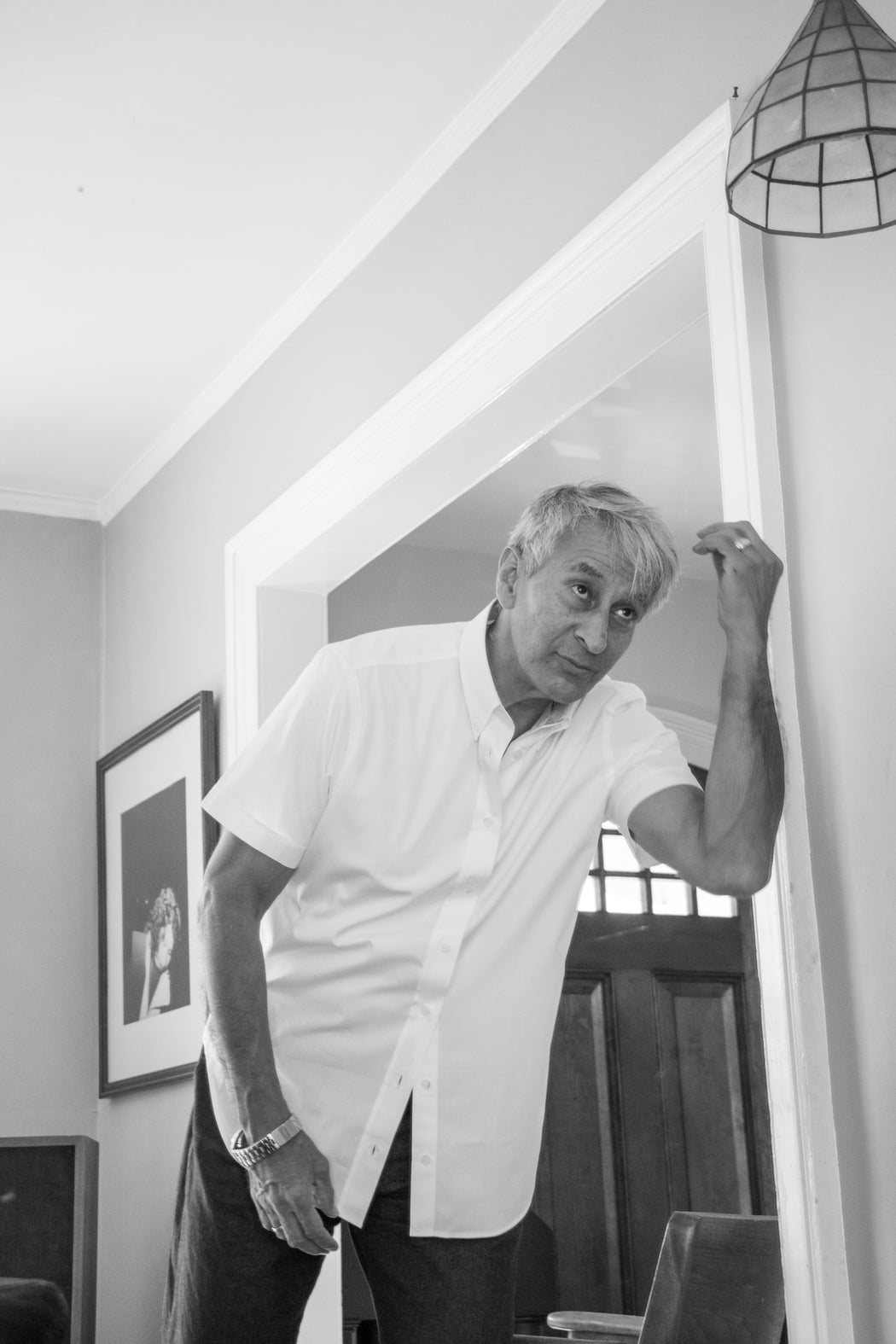 Black & white image of model wearing white short sleeve button down collar shirt