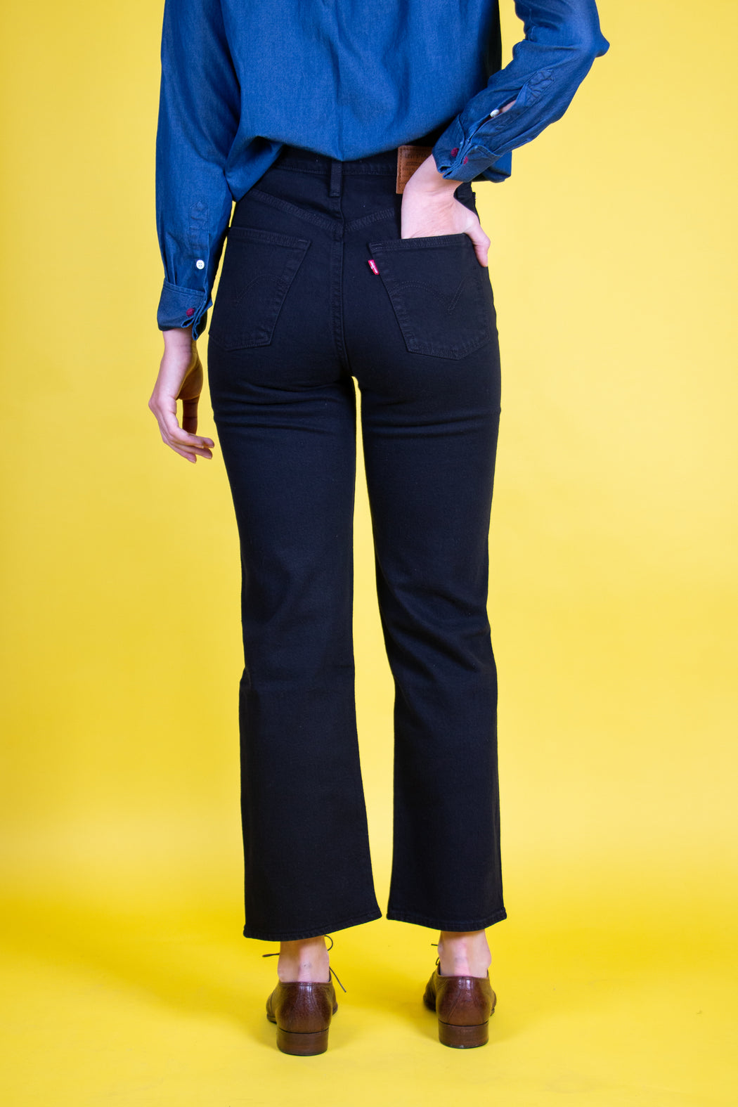 Back view:  Model wearing black Levi's Ribcage Straight Ankle Jean