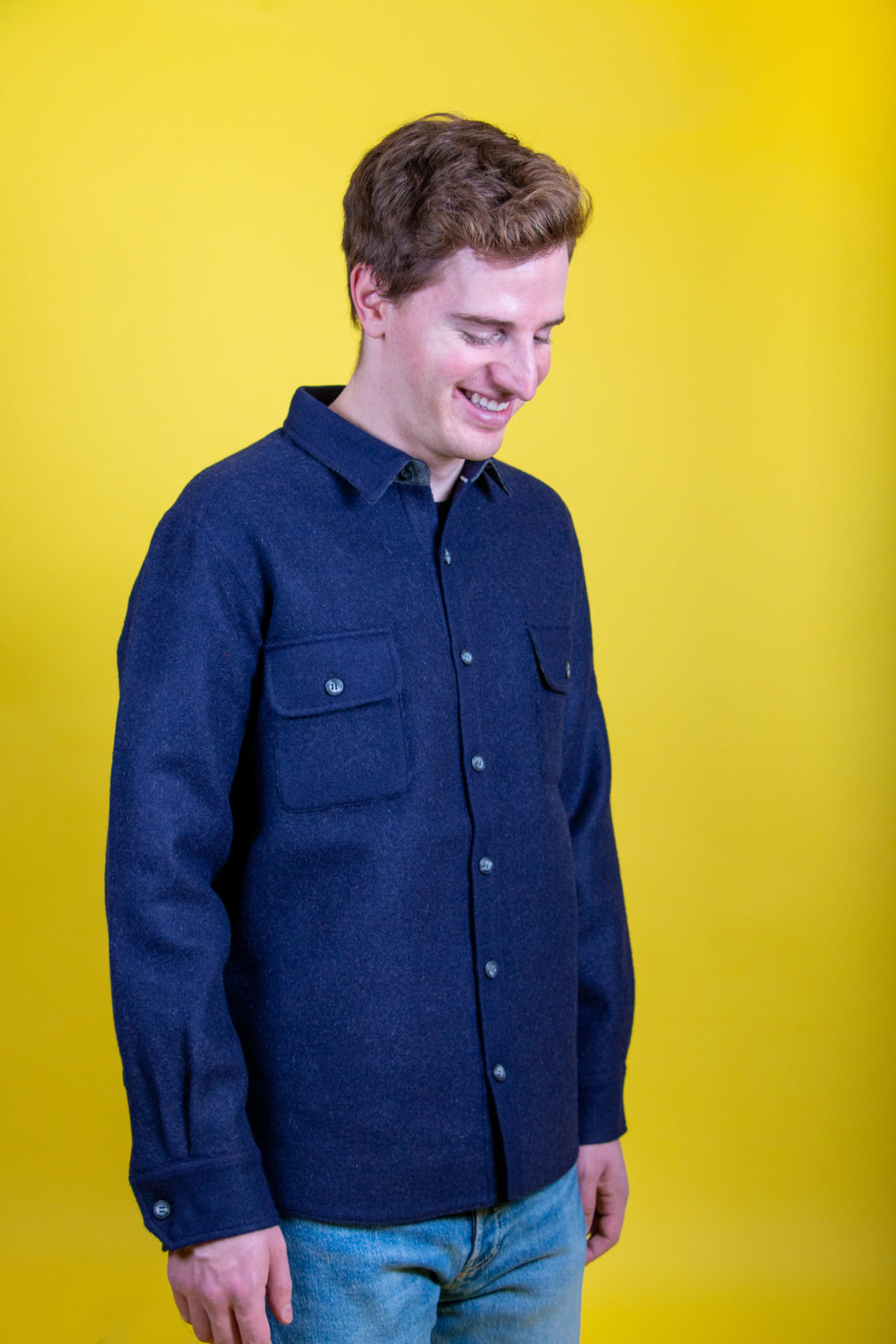 Model wearing dark blue utilitarian CPO over shirt