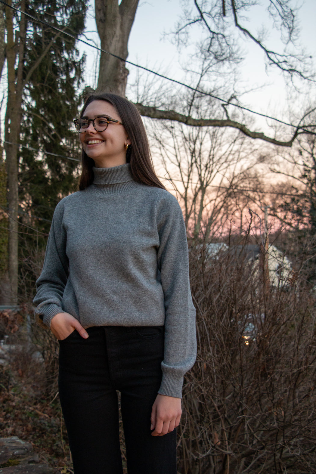 Female model wearing grey long sleeve turtleneck sweater