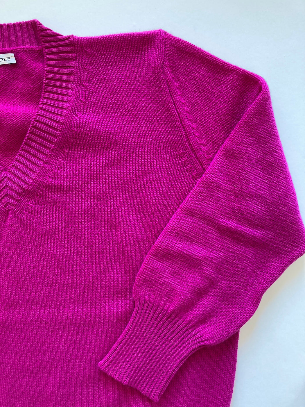 Close-up: Hot pink v-neck sweater
