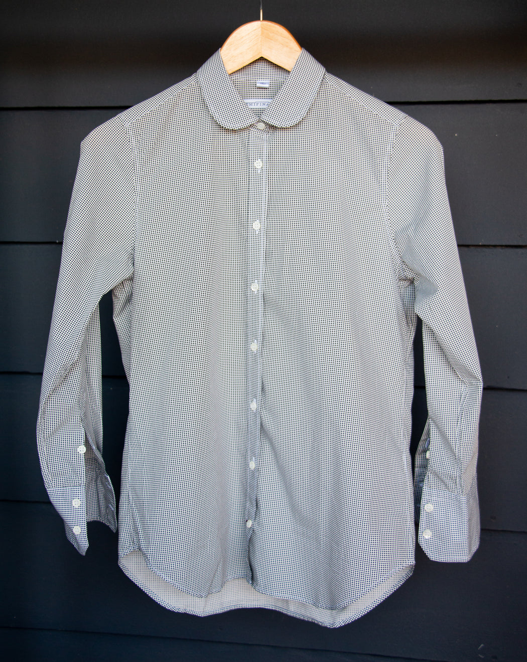 Semifinalist's black mini dot print on silky white poplin with a Peter Pan collar on wooden hanger