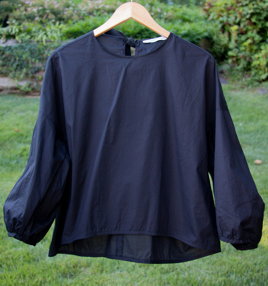 Black popover shirt on hanger