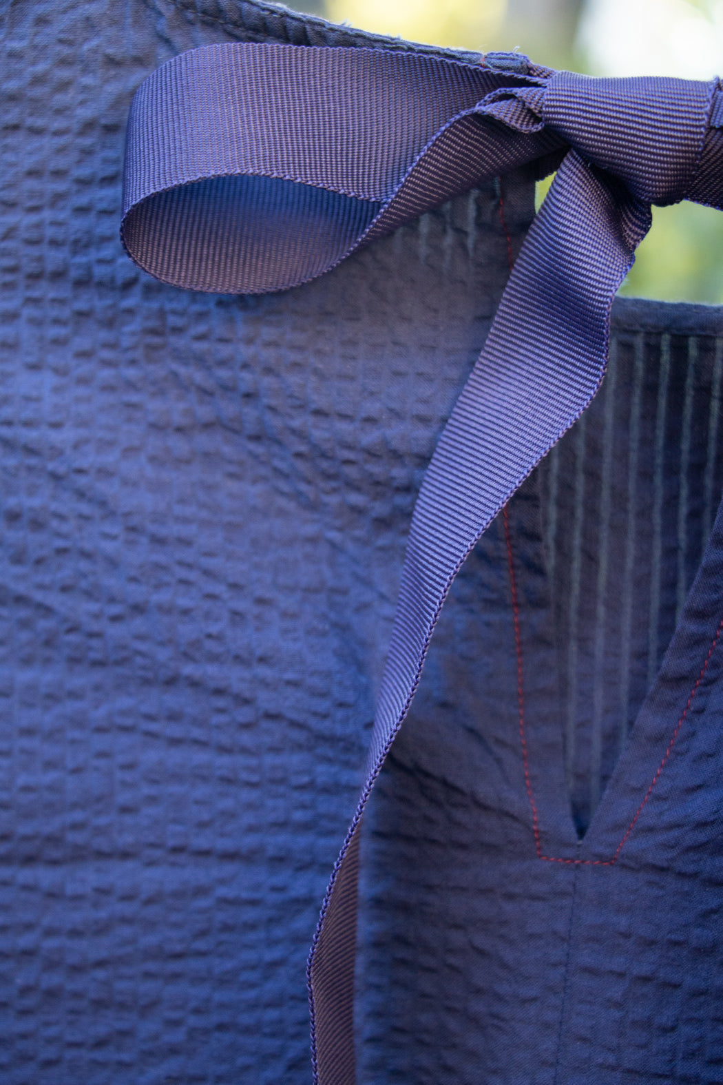 Dark blue ribbon tie back closure