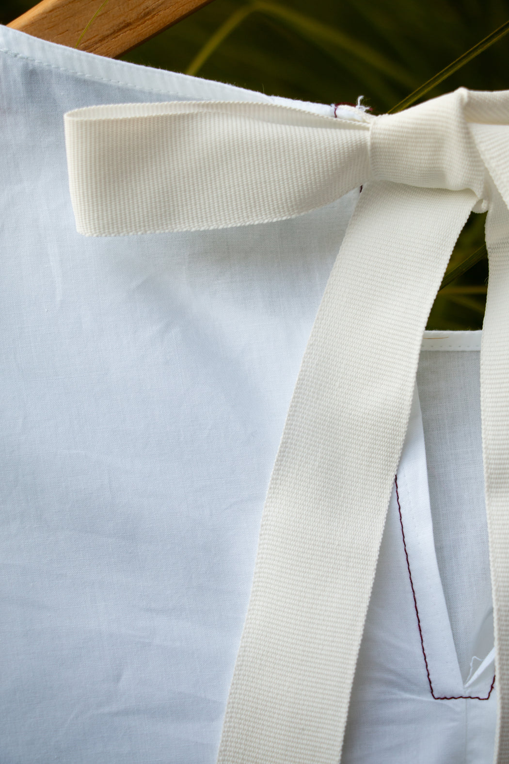 White ribbon tie back closure