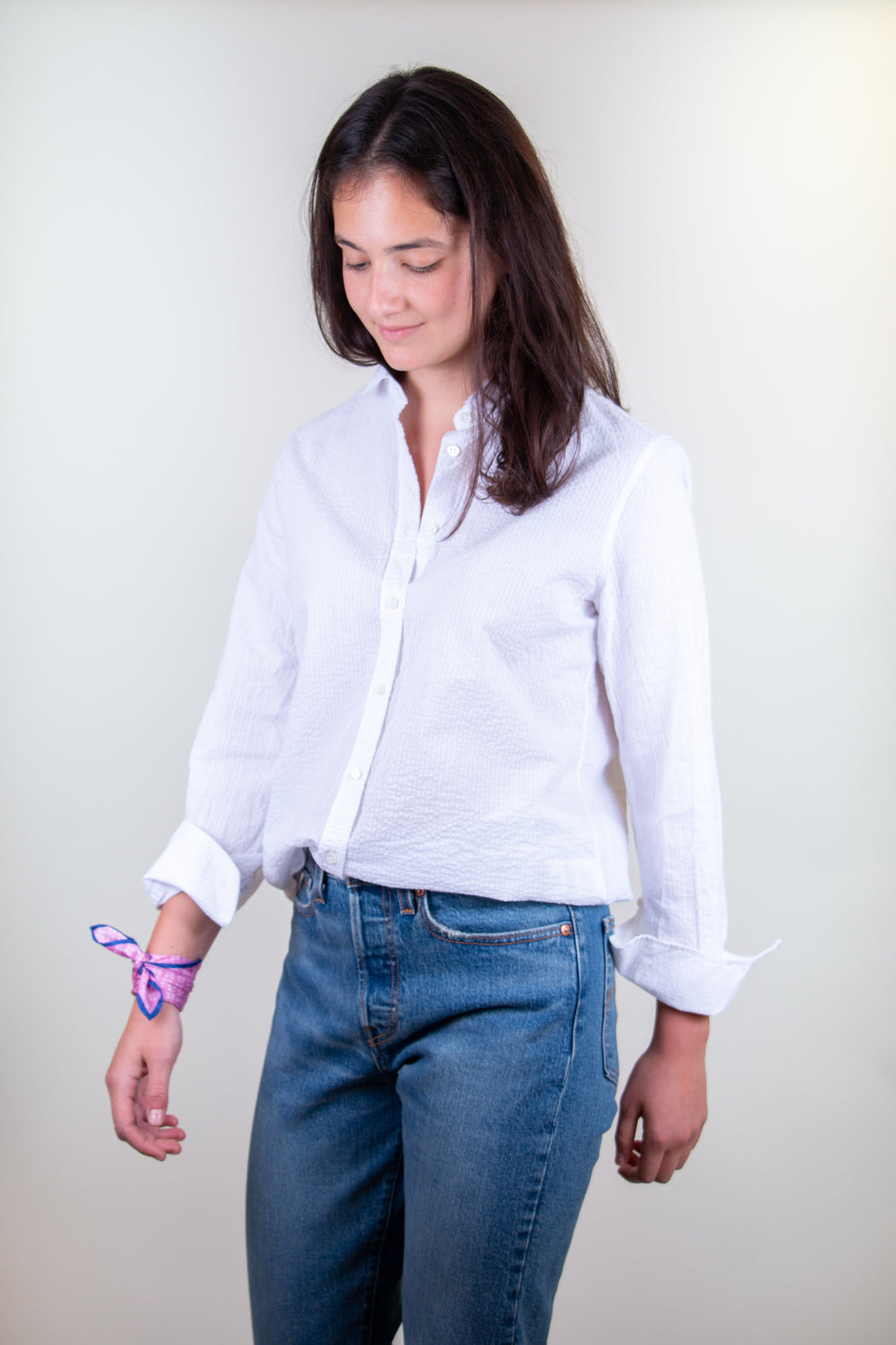 Model wearing white crinkle cotton button down shirt with Peter Pan collar