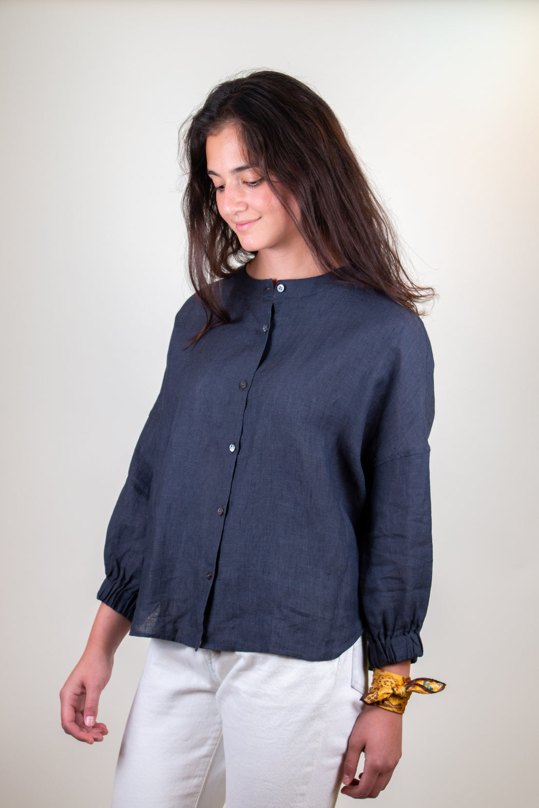 Model wearing blue grey long sleeve shirt with button front