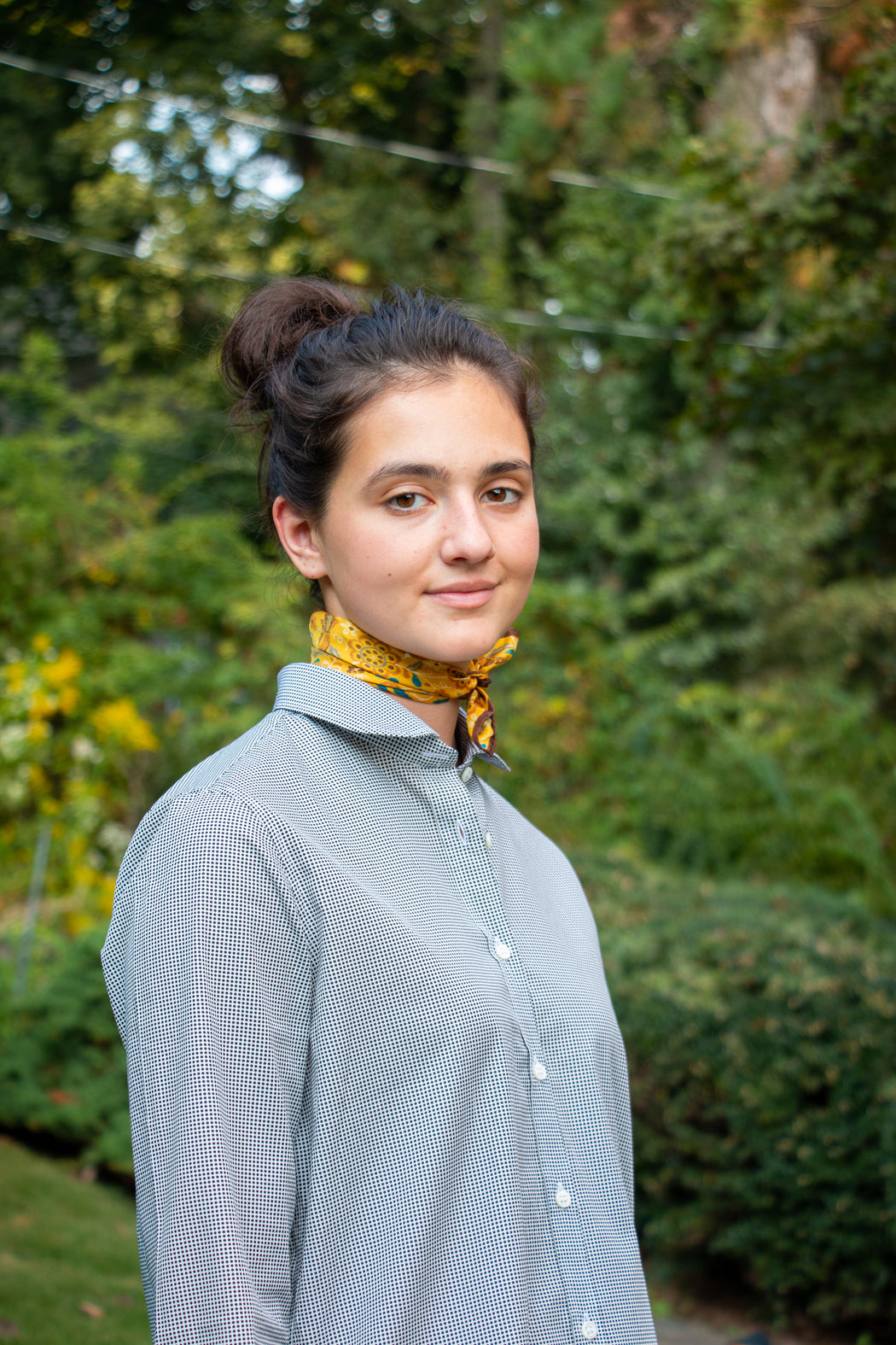 Model wearing Semifinalist's black mini dot print on silky white poplin with a Peter Pan collar