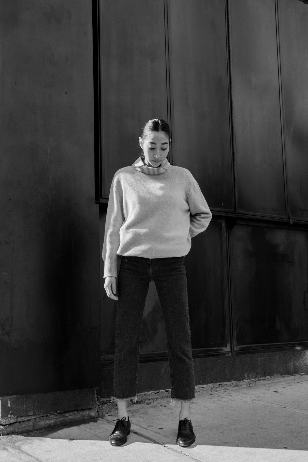 Model wearing tan long sleeve sweater with high neck