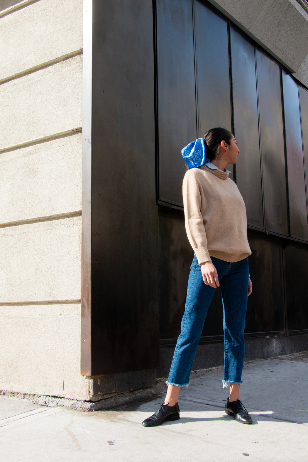 Classic blue silk bandana tied in model's hair