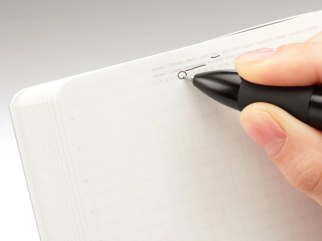 Close-up of a hand writing in a notebook