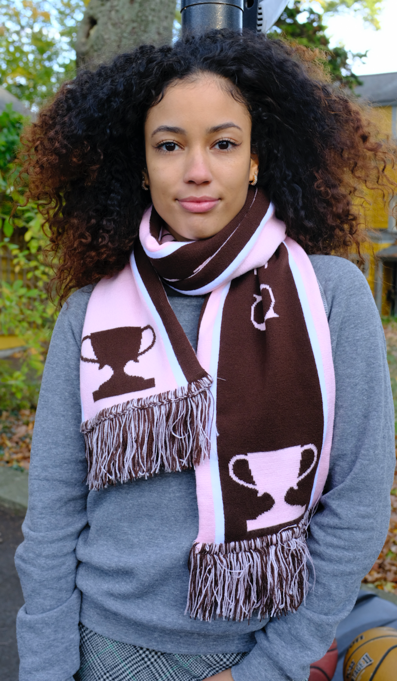 Female model wearing a brown & pink Semifinalist soccer scarf around her neck