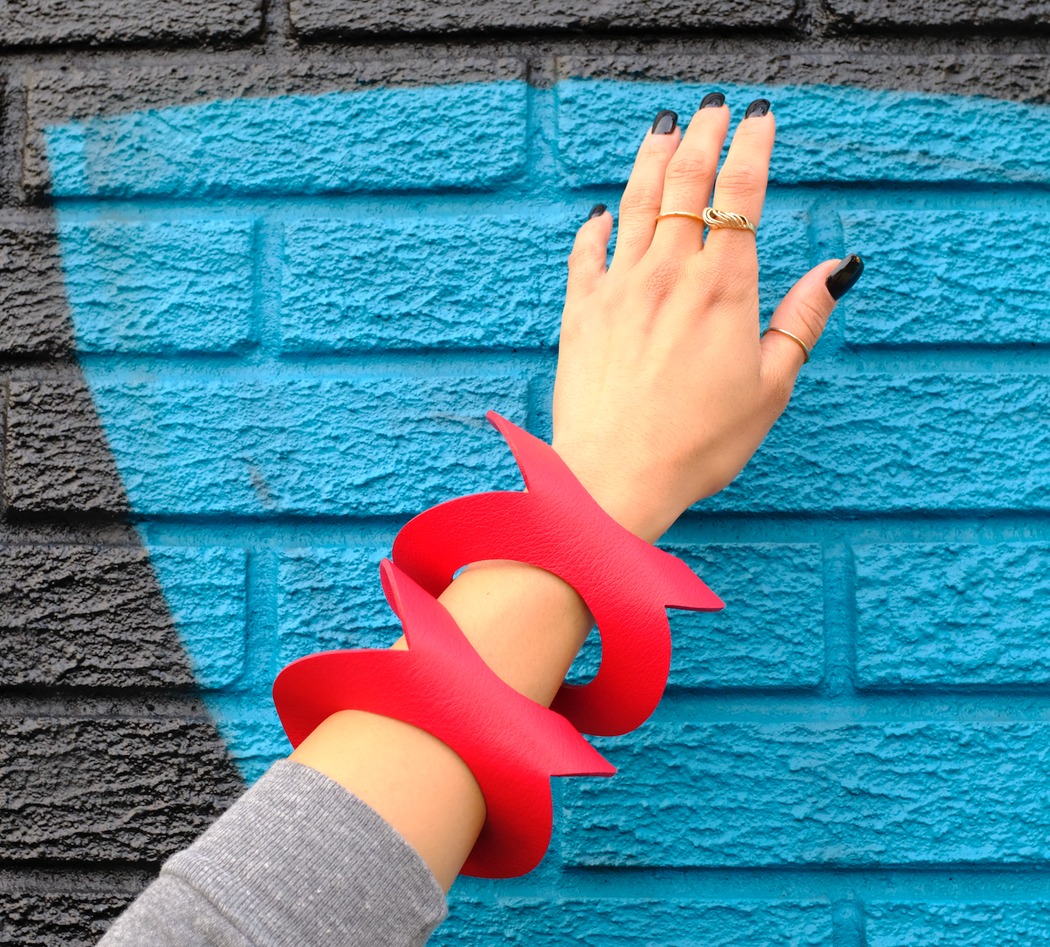 Red leather bracelet worn on model's arm