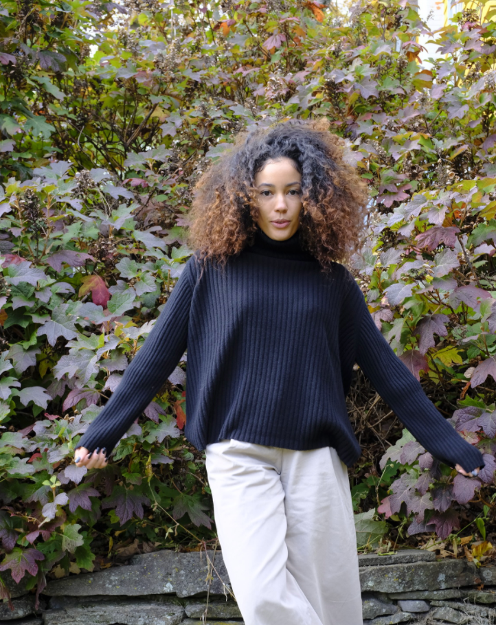 Girl wearing black long sleeve turtleneck sweater