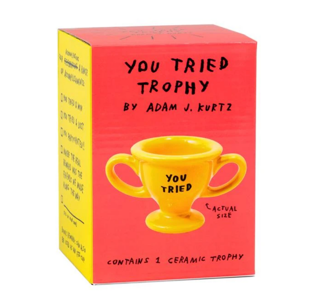 Red and yellow box containing the "You Tried" Trophy Egg Cup, by Adam J. Kurtz