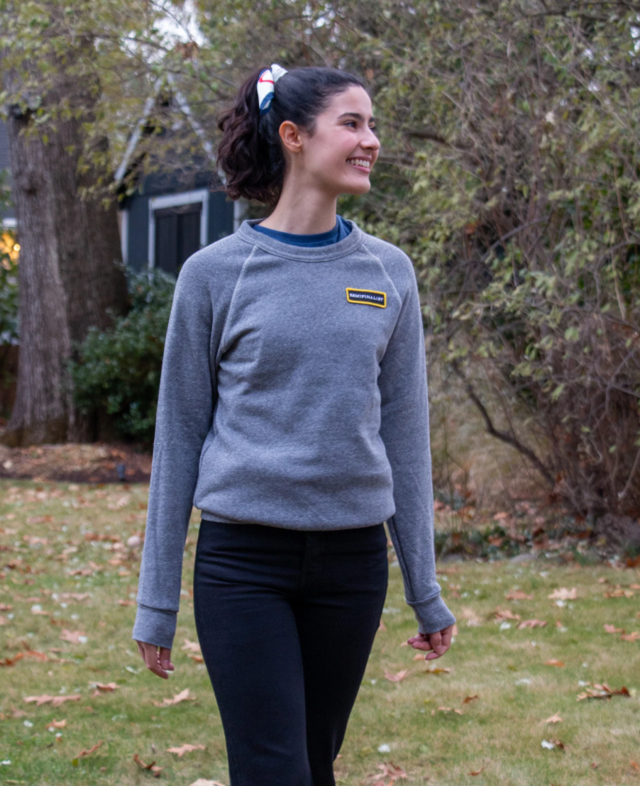 Female model wearing grey long sleeve Semifinalist Team Sweatshirt