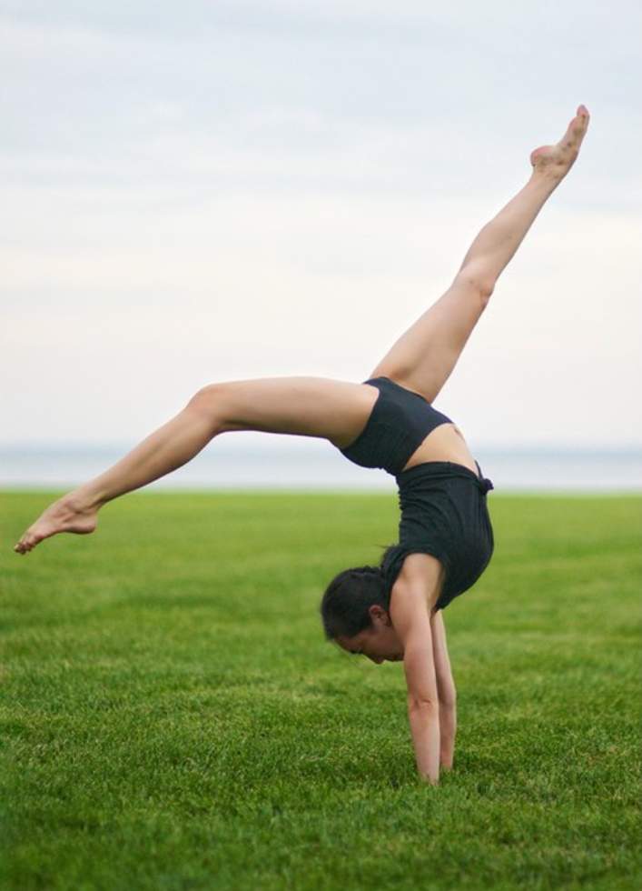 Girl in handstand pose wearing black high waist women's underwear