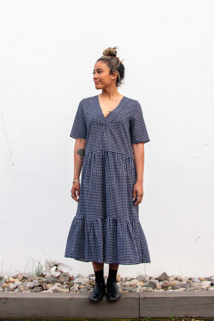 Girl wearing navy & white polka dot short sleeve petticoat dress with V-neck