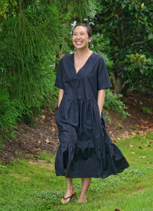 Model wearing black short sleeve petticoat dress with V-neck