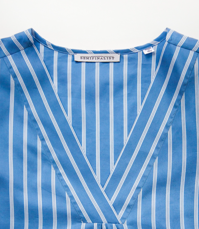 Close-up on V-neck of blue & white striped petticoat dress