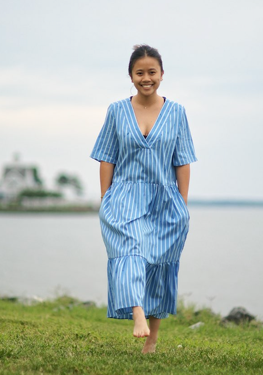 Girl wearing blue & white striped short sleeve petticoat dress with V-neck