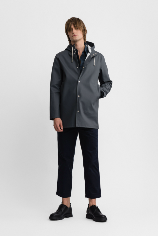 Male model wearing gray long sleeved rain jacket with hood