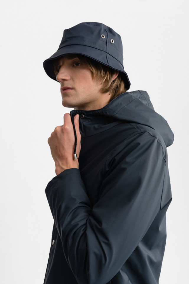 Male model wearing navy bucket hat