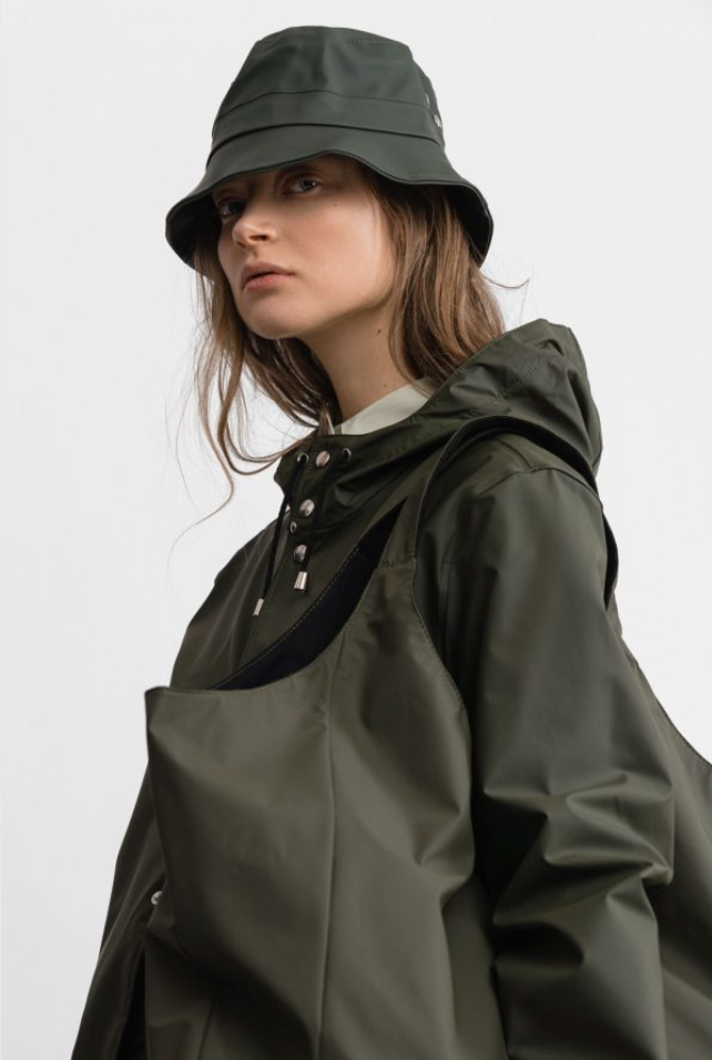 Female model wearing olive green bucket hat