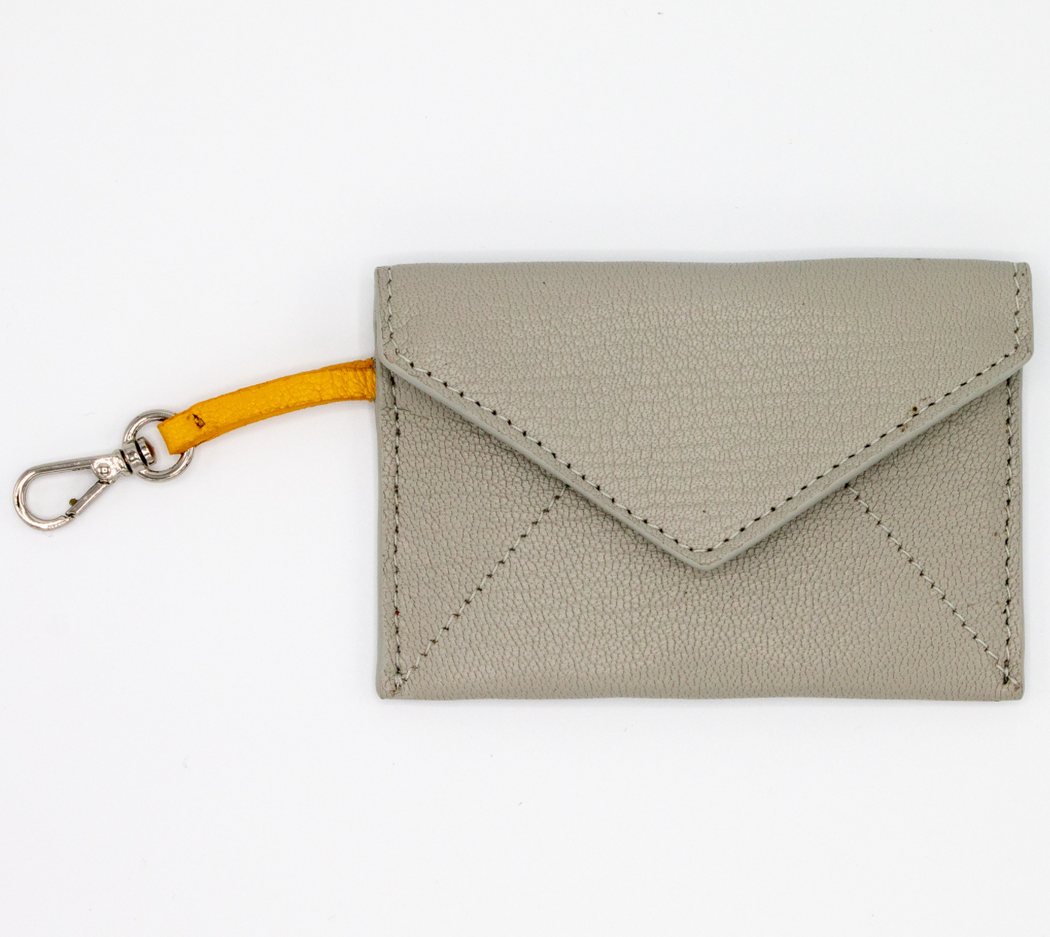 Grey leather card case with v-shape flap and yellow clip strap