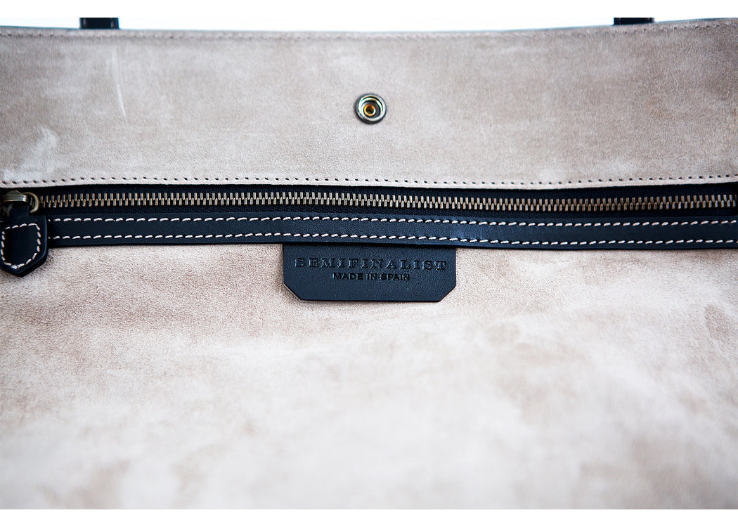 Interior brass zipper pocket detail, with Semifinalist logo