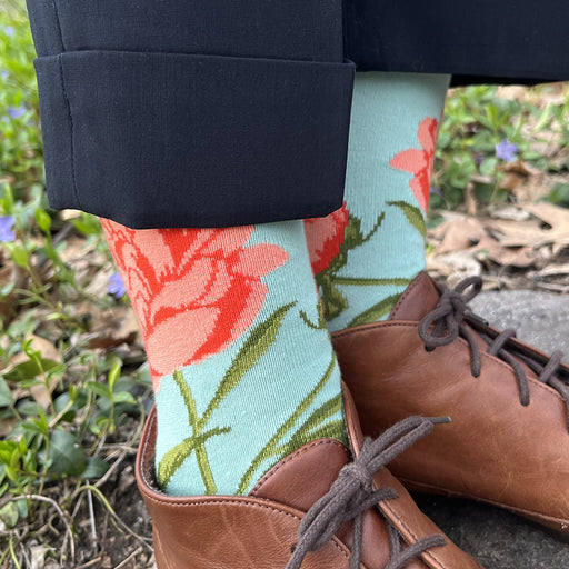 Model wearing Aqua colored sock with pink peony design and brown shoes