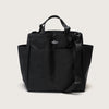 Black tote bag with snap closure, exterior pockets, top handles & shoulder strap (front view)