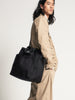 Male model wearing black canvas tote bag  with shoulder strap