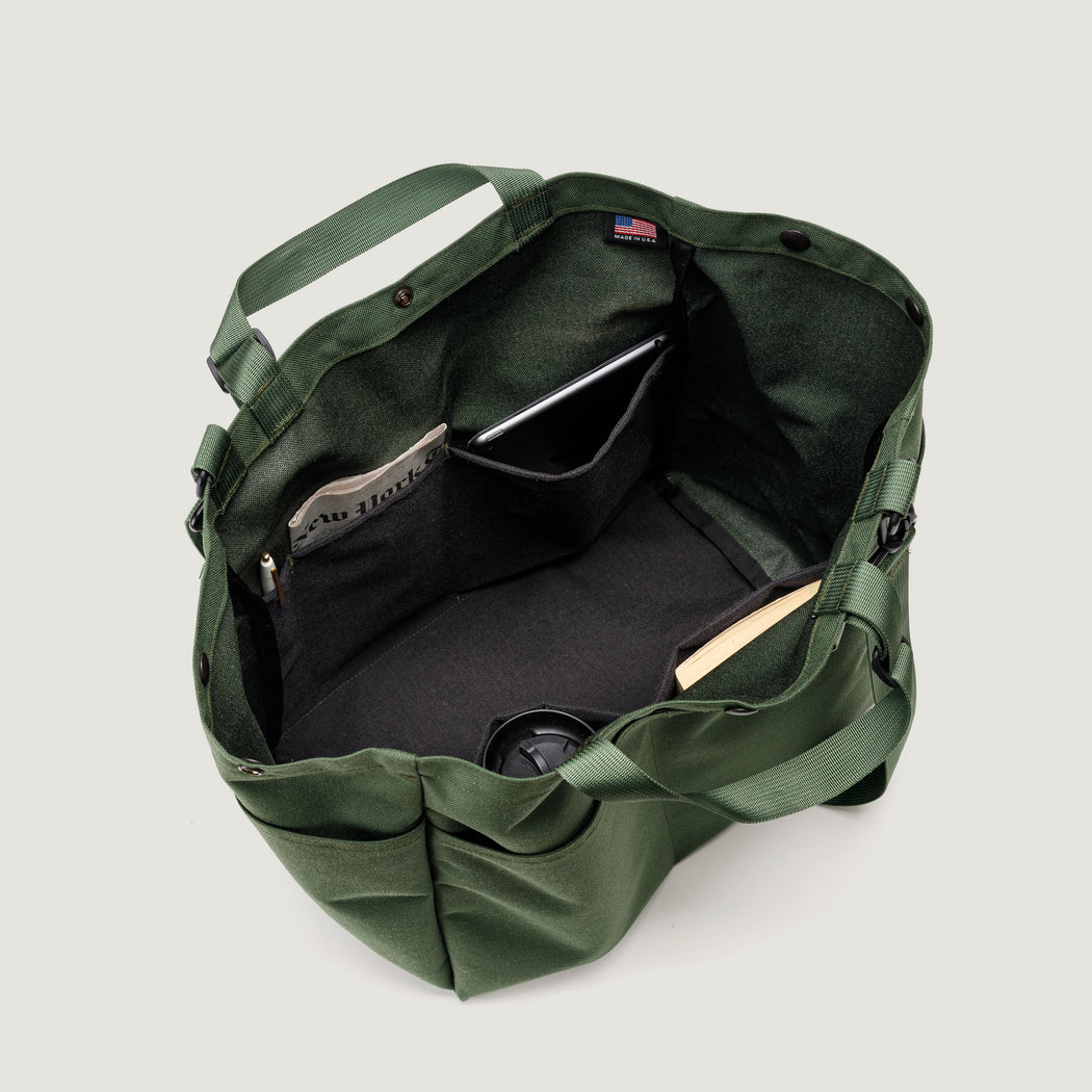 Olive colored tote bag with snap closure, exterior pockets, top handles & shoulder strap (interior view)