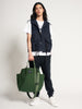 Male model holding olive green colored canvas tote bag by the handles 