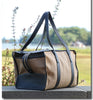 Three quarter view: Tan cotton twill weekender bag with leather handles