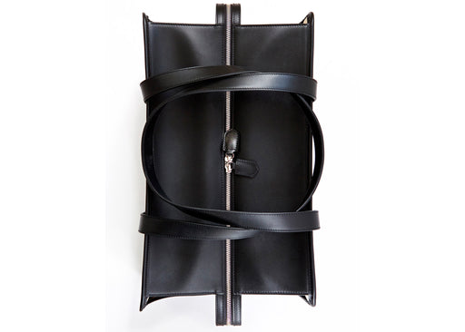 Top view:  Black leather travel bag with shoulder straps and nickel zipper closure