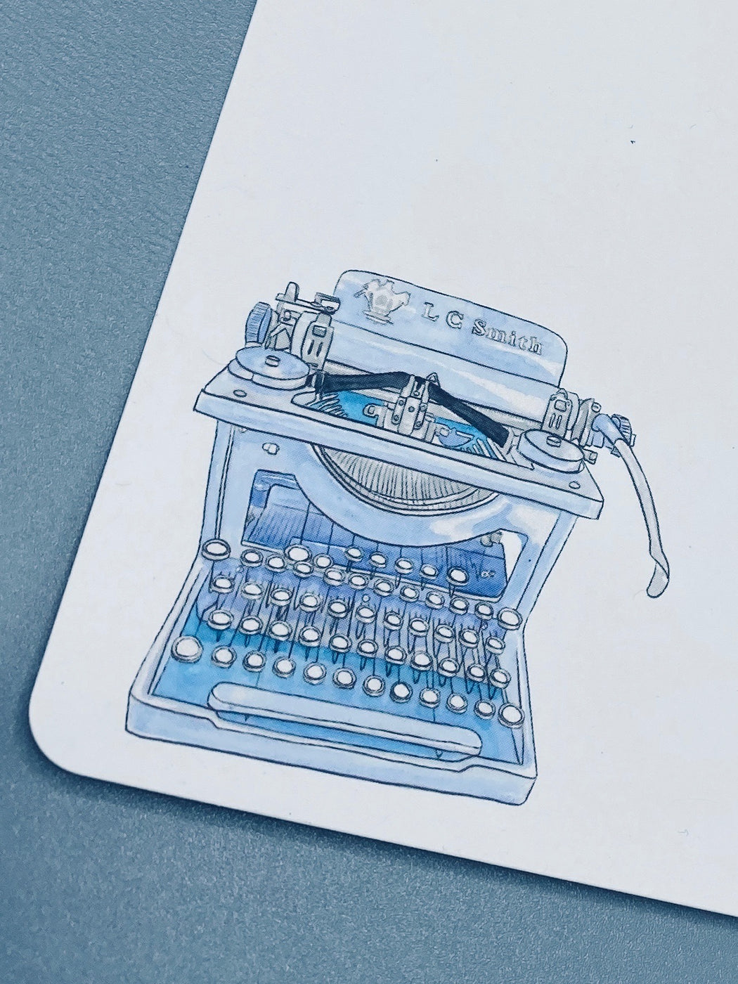 Notecard illustration of a blue typewriter