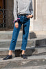 Model wearing Wedgie Straight Fit Ankle Jeans with pink pocket square tied around her wrist