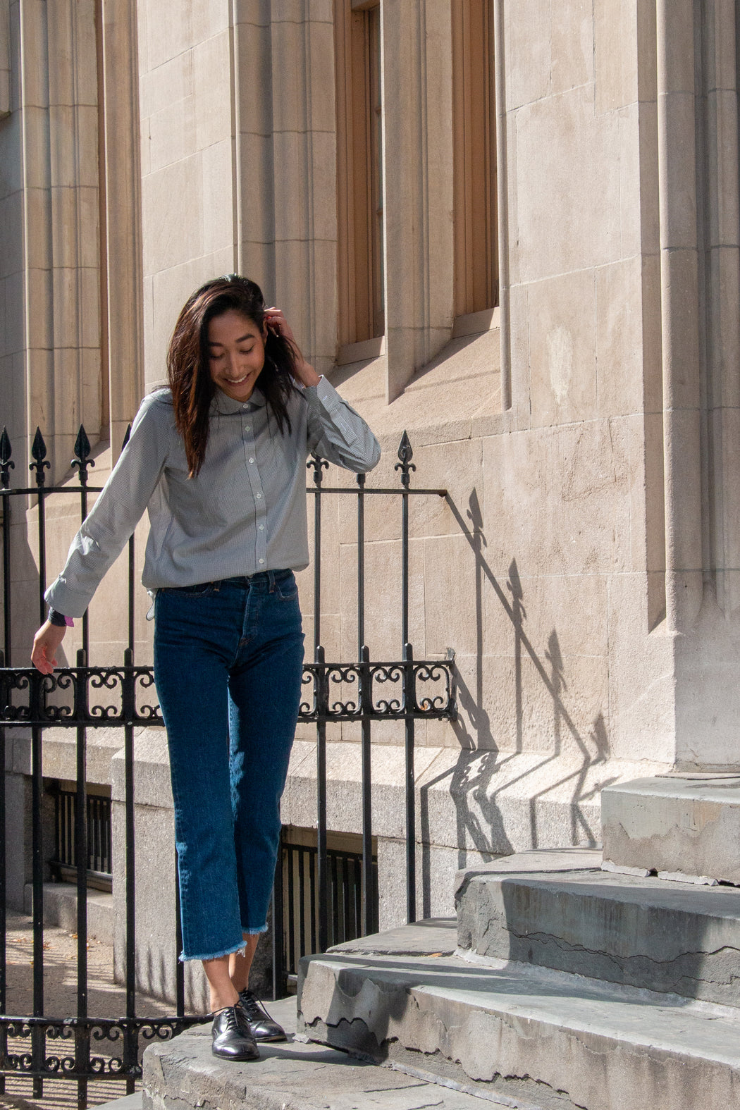 Model standing on steps, wearing Wedgie Straight Fit Ankle Jeans