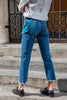 Back view: Model wearing Wedgie Straight Fit Ankle Jeans with blue pocket square coming out of back pocket