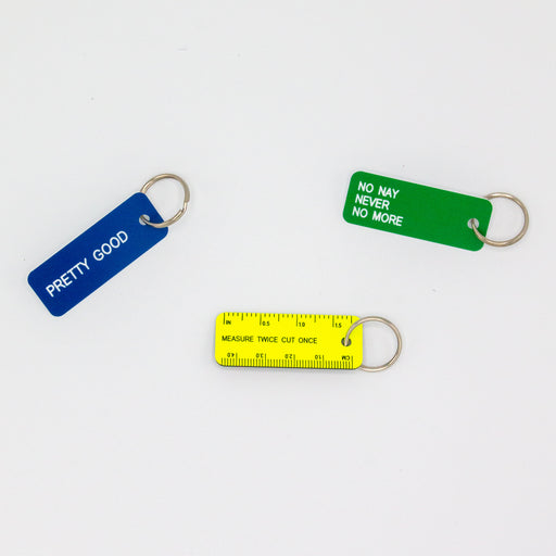 Three key tags shown together, blue tag states "pretty good", green tag states "no nay never no more" and yellow tag looks like a mini ruler and states "measure twice cut once"